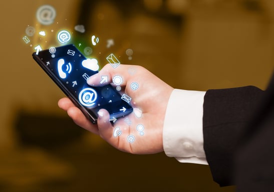 Business man holding smart phone with media icons concept on background