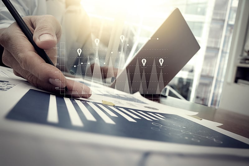 business documents on office table with smart phone and digital tablet and graph financial with social network diagram and man working in the background business documents on office table with smart phone and digital tablet and graph financial with social network diagram and man working in the background