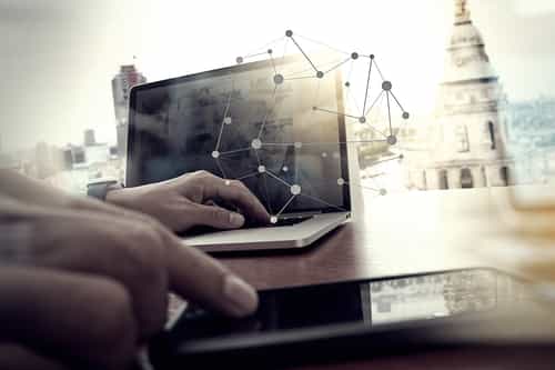 designer hand working and smart phone and laptop on wooden desk in office with london city background designer hand working and smart phone and laptop on wooden desk in office with london city background